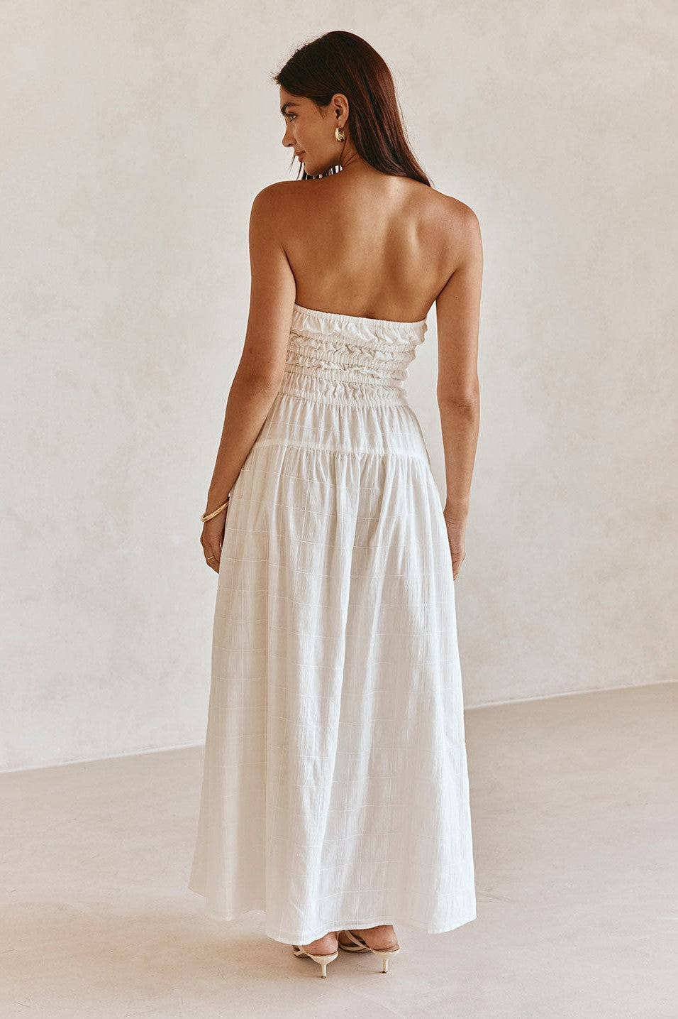 White maxi dress with a strapless neckline, back view