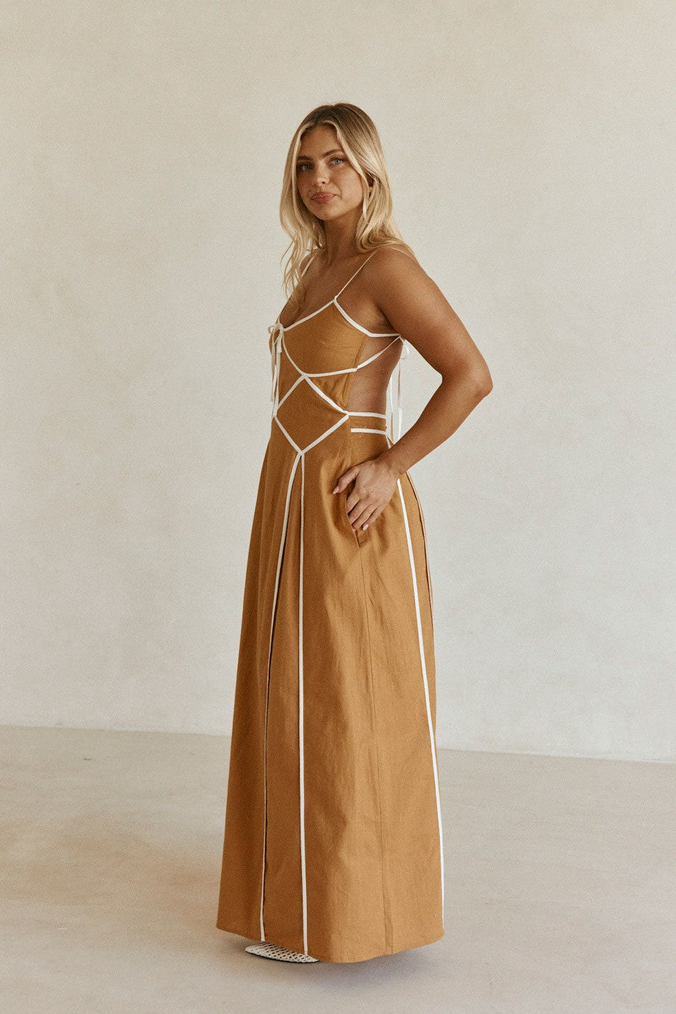 Tan maxi dress with an open back, styled on model