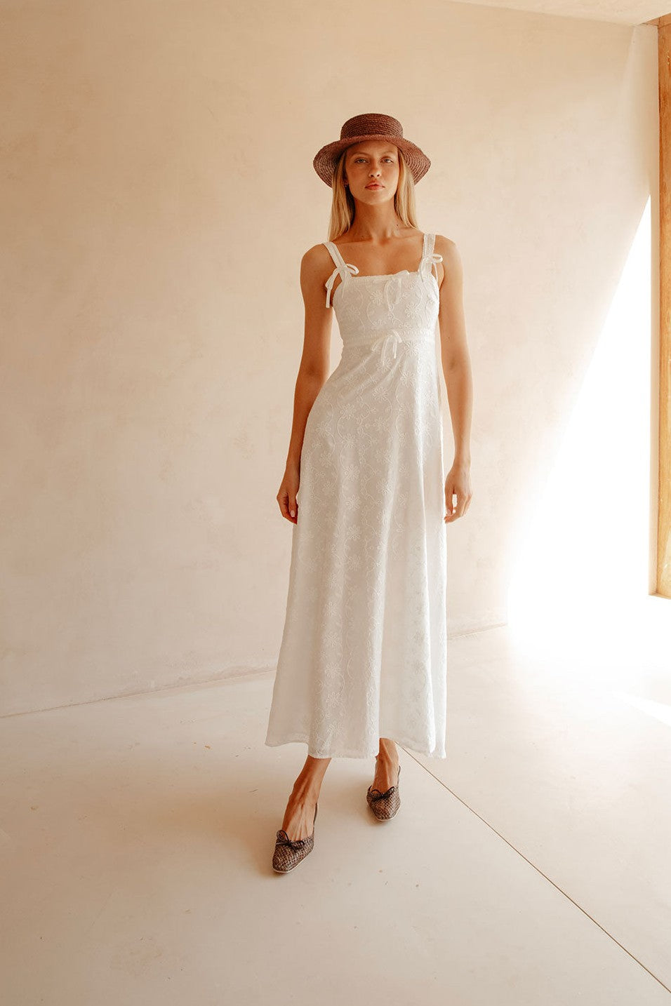 White maxi dress with an A-line skirt, side view