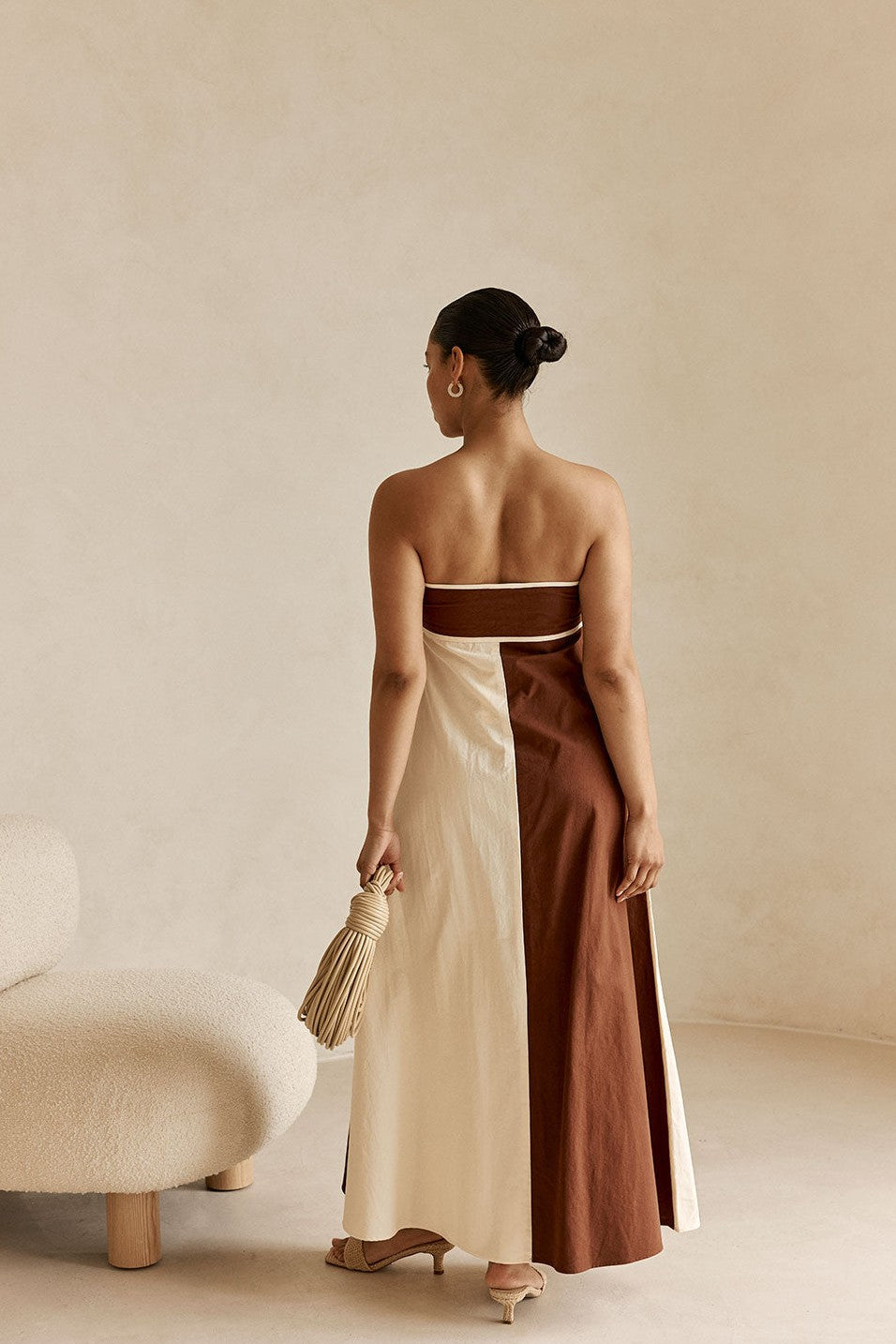 Cream maxi dress with a strapless neckline, styled on model