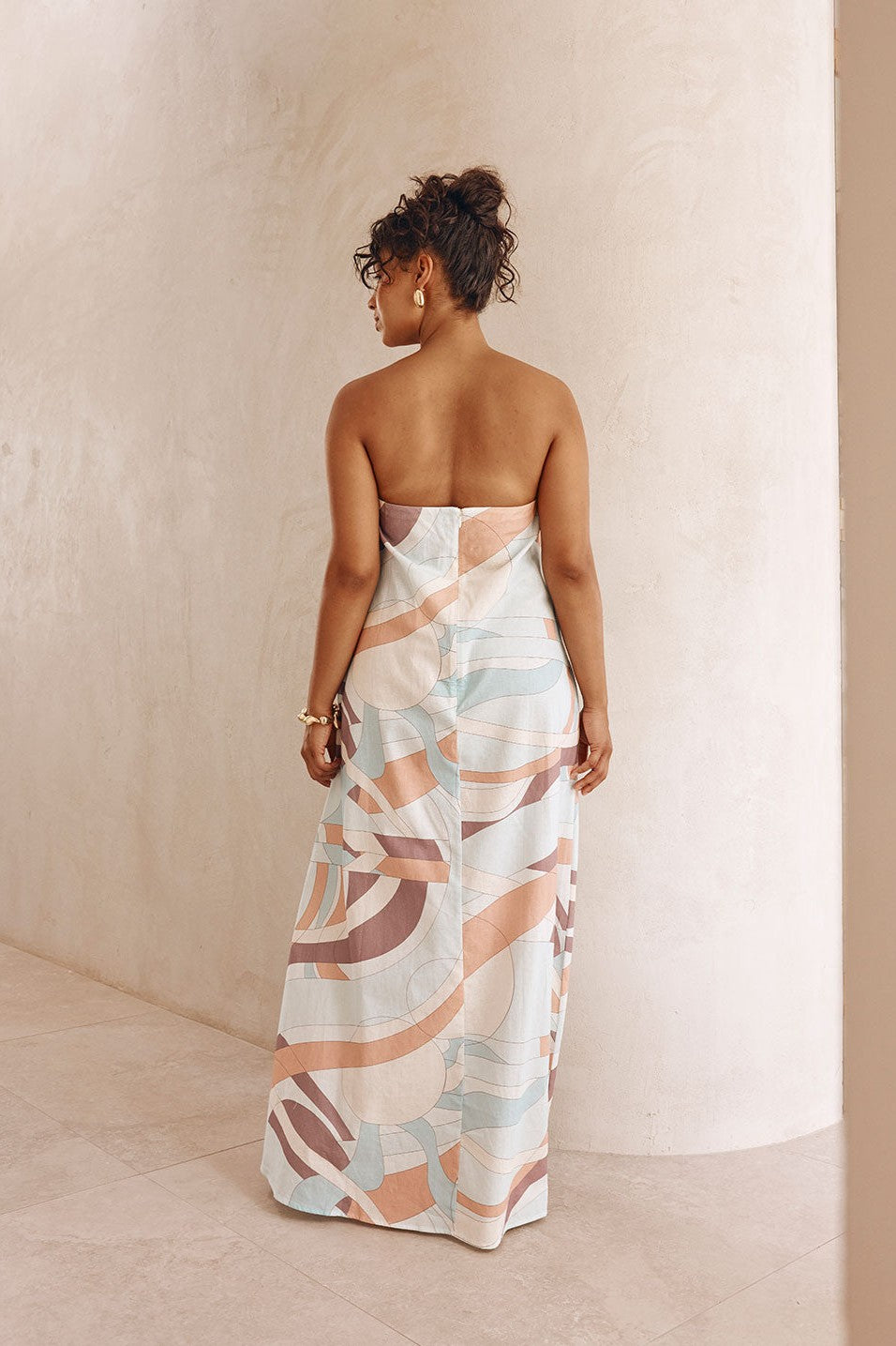 Blue maxi dress with a strapless neckline, side view