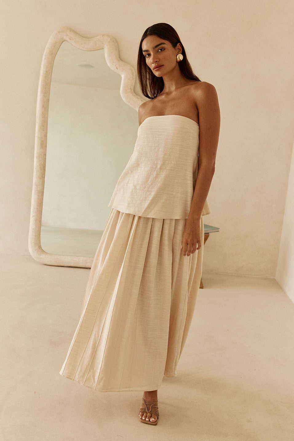 Beige maxi dress with a strapless neckline, side view