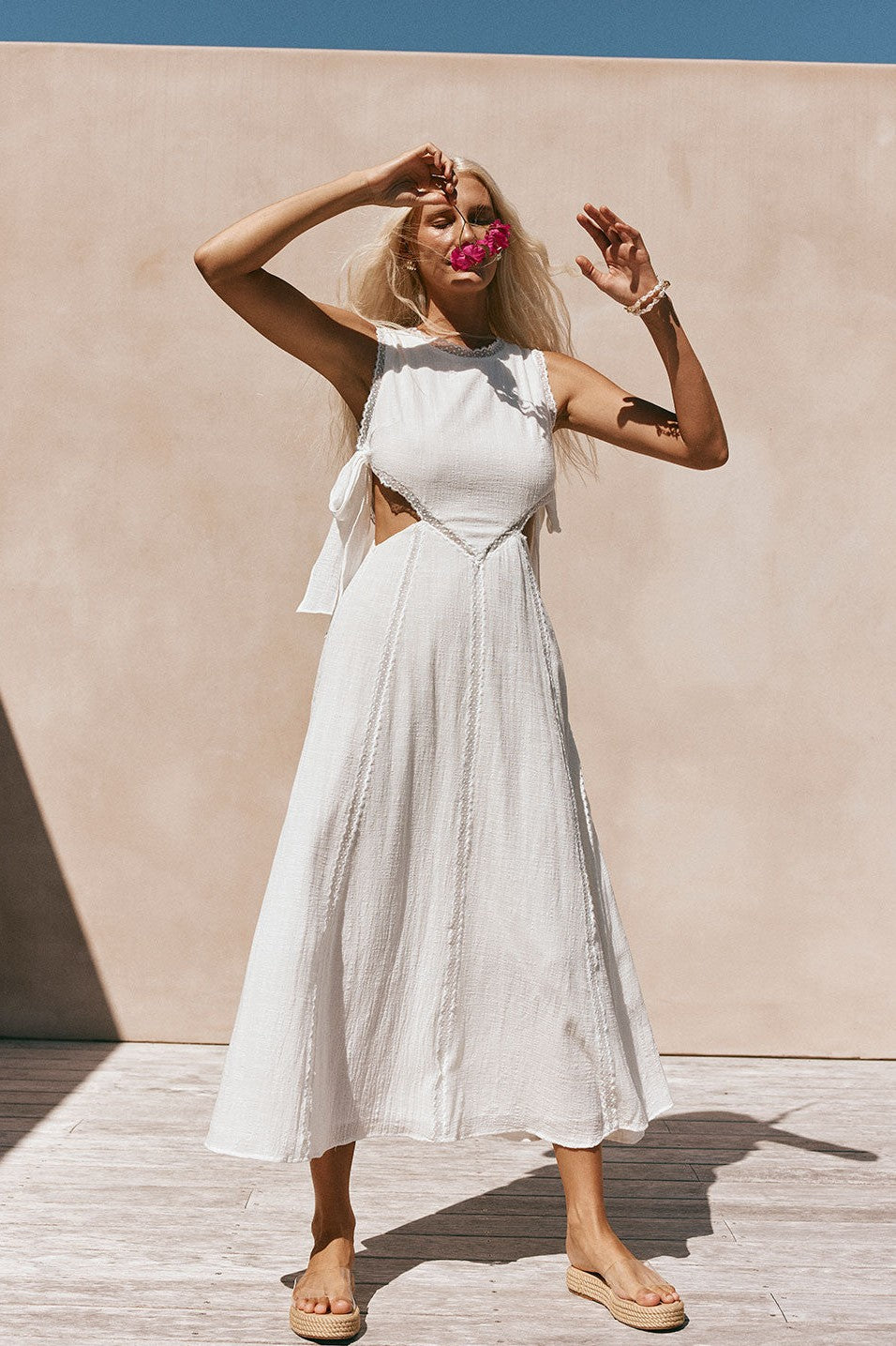 White maxi dress with an A-line skirt, side view