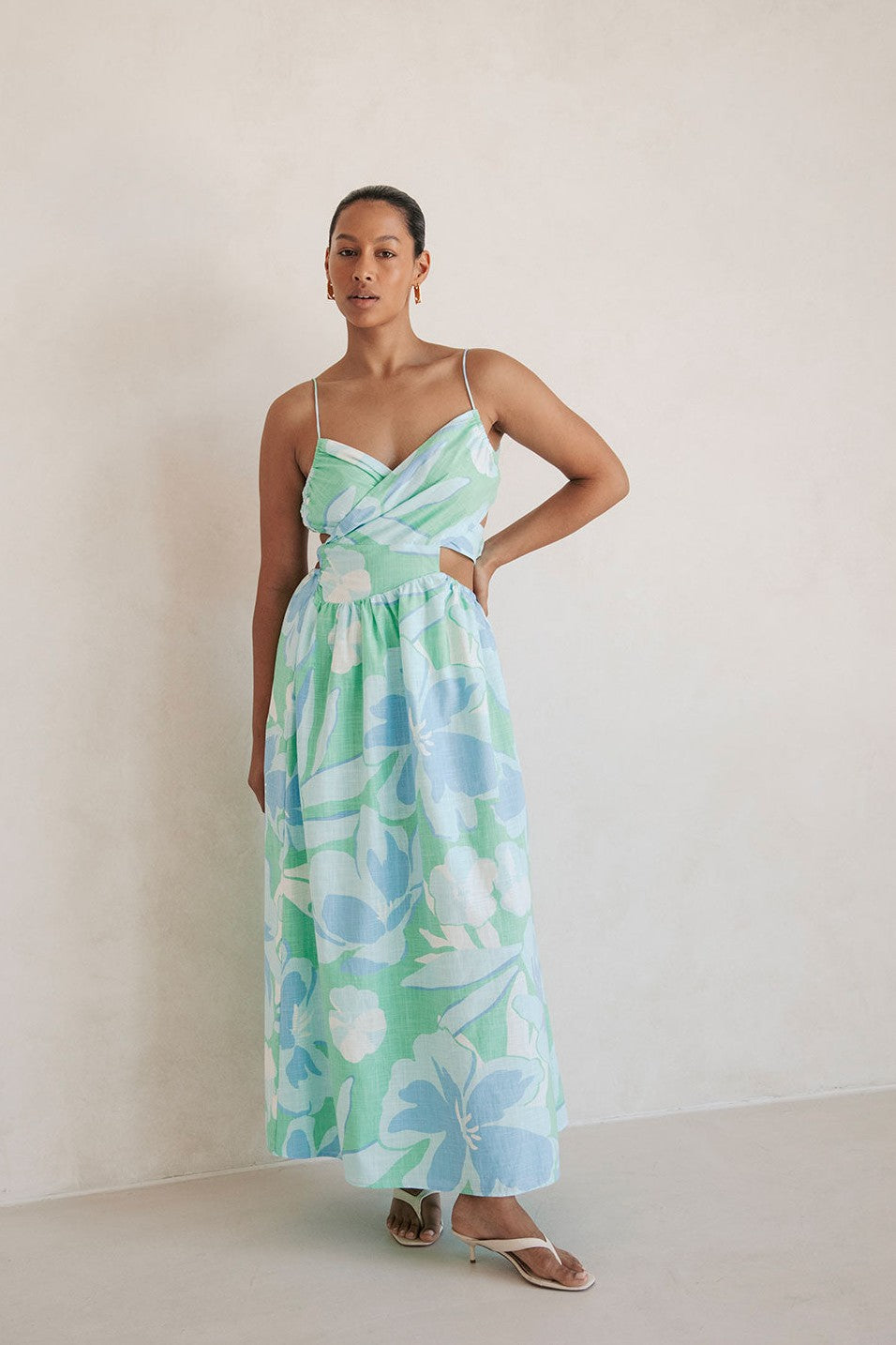 Blue midi dress with an open back, styled on model