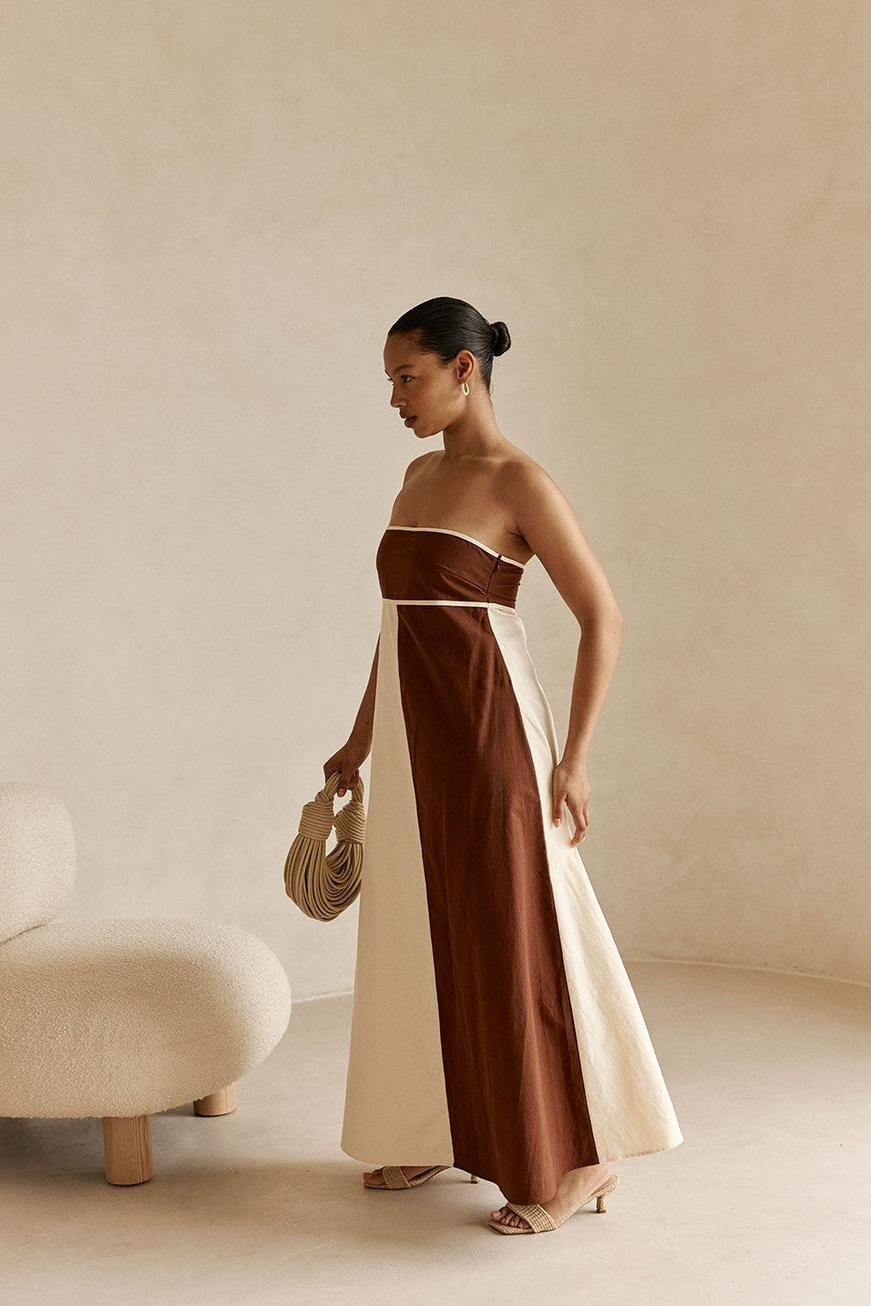 Cream maxi dress with a strapless neckline, detail view
