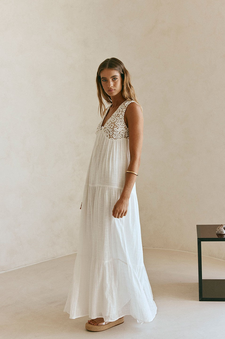 White maxi dress with a V neckline, side view
