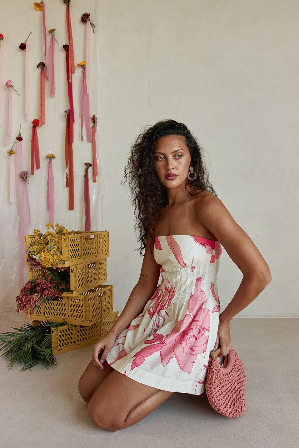 Pink mini dress with a strapless neckline, styled on model