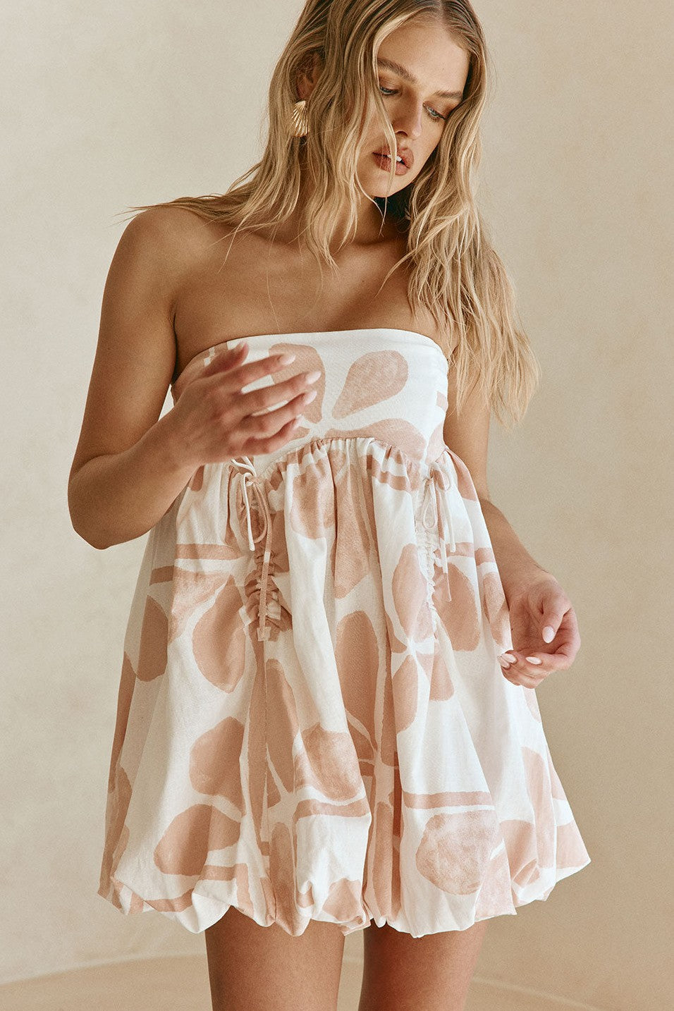Pink mini dress with a strapless neckline, side view