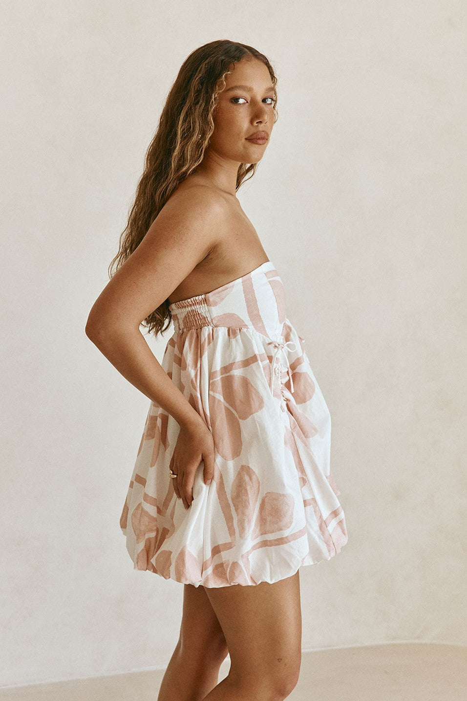 Pink mini dress with a strapless neckline, front view
