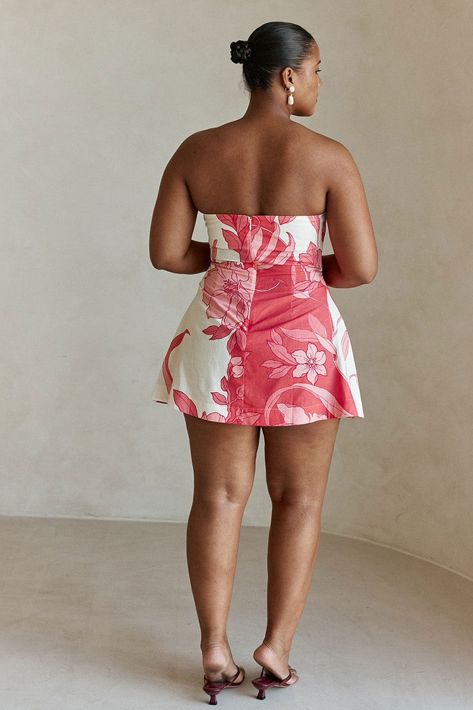 Pink mini dress with a strapless neckline, detail view