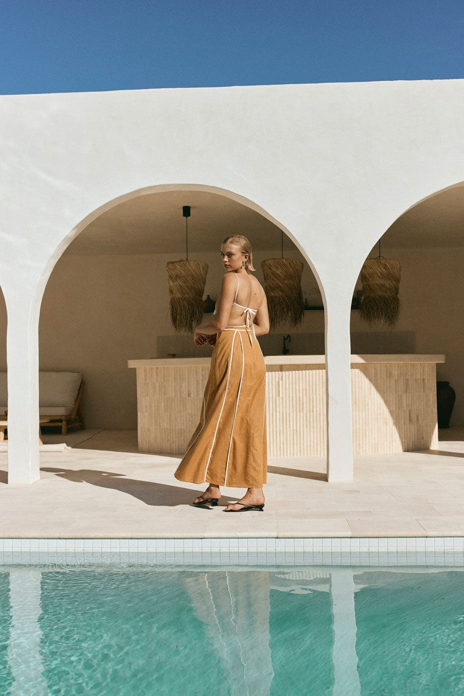 Tan maxi dress with an open back, detail view