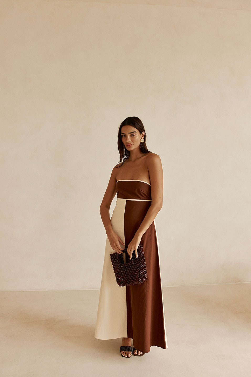 Cream maxi dress with a strapless neckline, side view