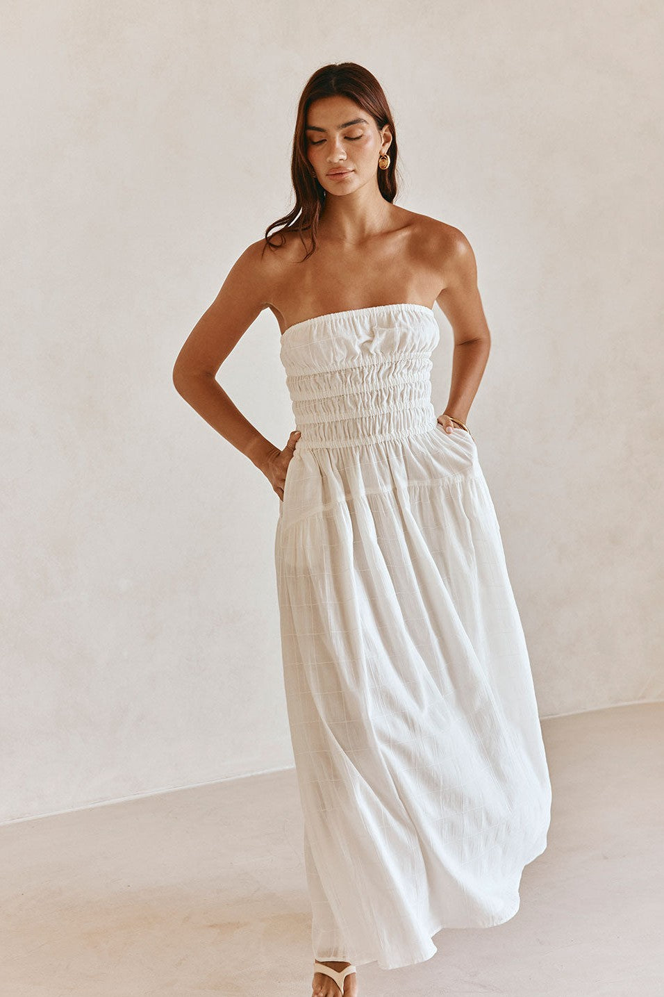 White maxi dress with a strapless neckline, styled on model