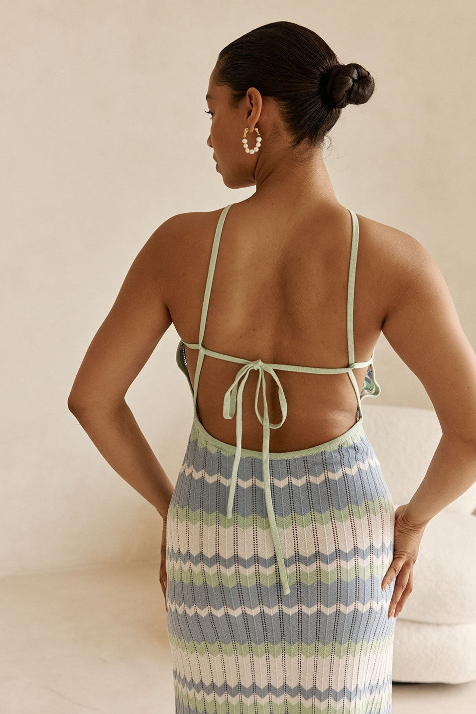 Blue maxi dress with a halter neckline, side view