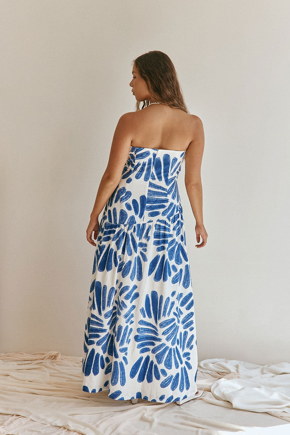 Blue maxi dress with a strapless neckline, styled on model