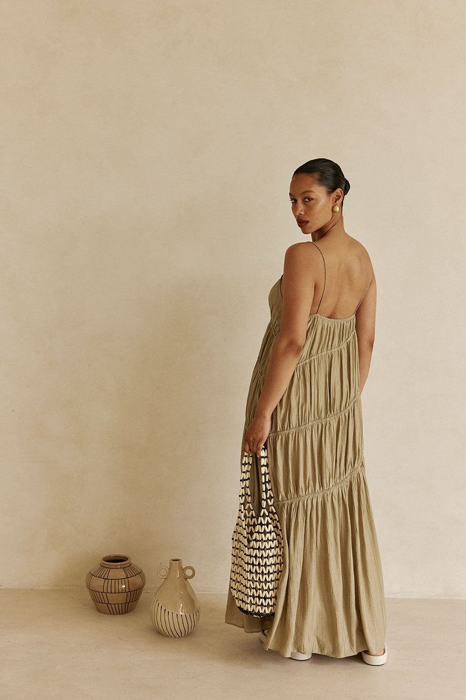 Green maxi dress with slim tie straps, styled on model