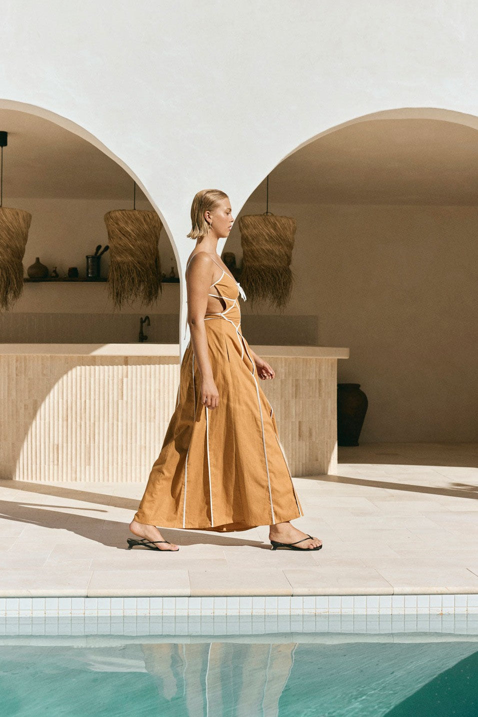 Tan maxi dress with an open back, side view