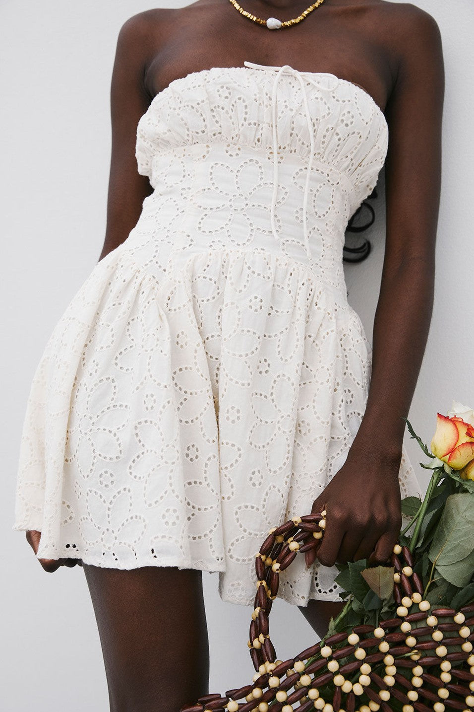 Beige mini dress with a strapless neckline, side view