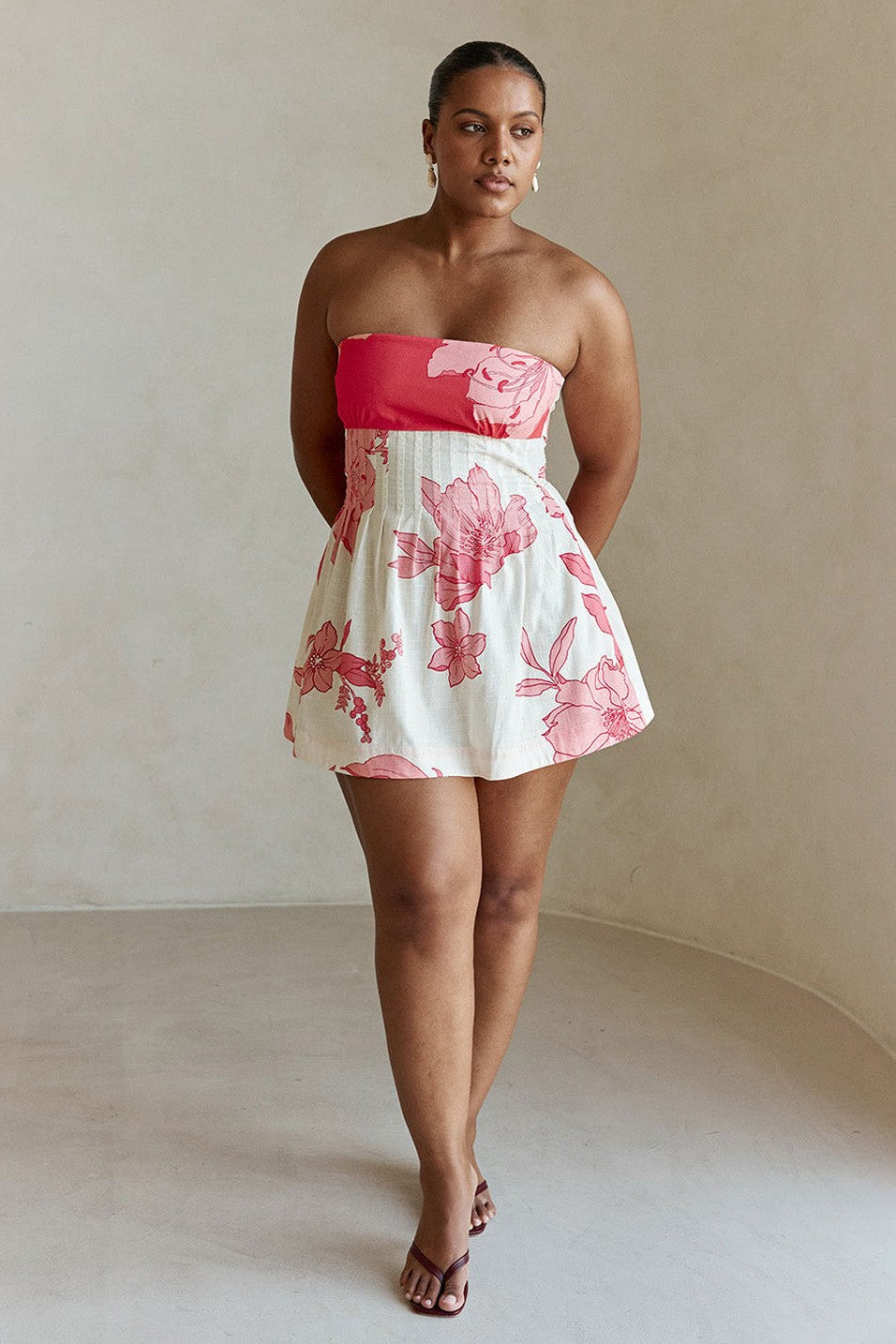 Pink mini dress with a strapless neckline, detail view