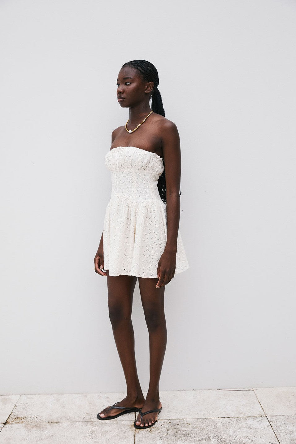 Beige mini dress with a strapless neckline, detail view
