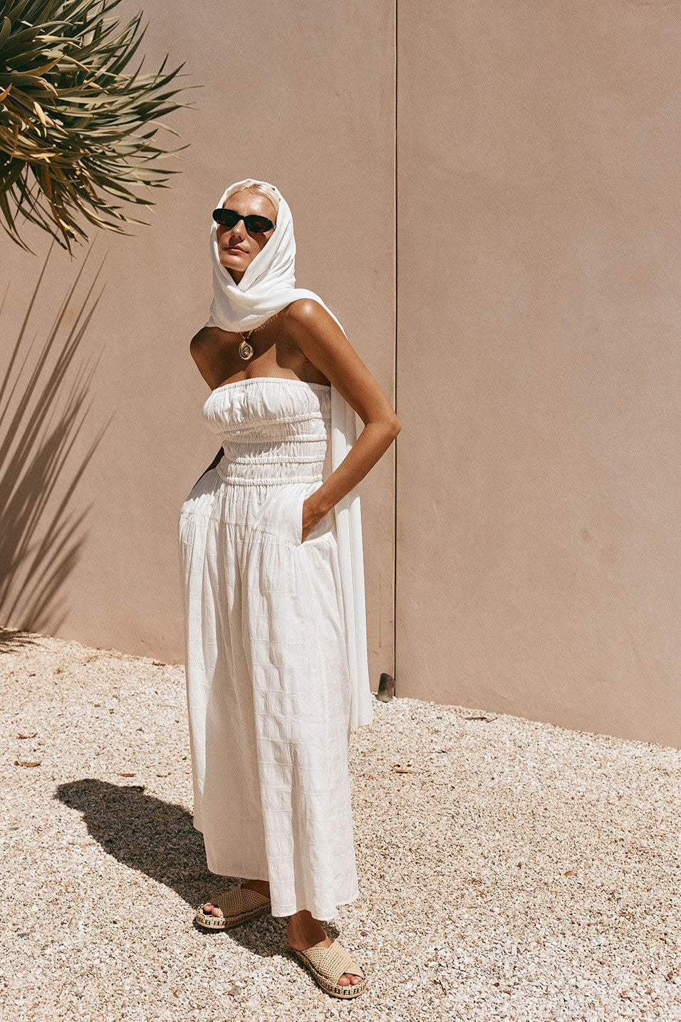 White maxi dress with a strapless neckline, side view